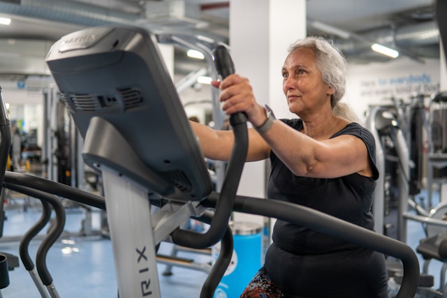 woman on elliptical in senior fitness program