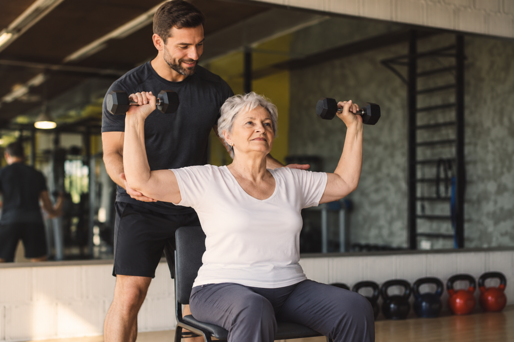 1 on 1 senior fitness training using light dumb bells